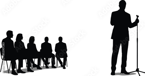 Silhouette of a businessman speaking into a microphone at a stand while a diverse audience sits in chairs listening intently