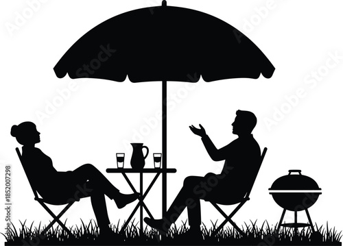 Silhouette of a couple relaxing in garden chairs under an umbrella by a barbecue grill, talking and enjoying summer leisure