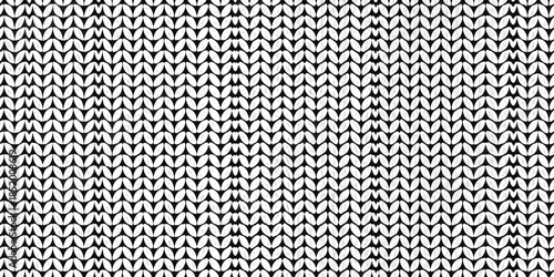 Close up of a textured white knitted fabric with a repeating pattern