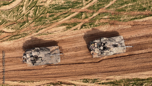 Aerial Top Down Merkava Tanks Gaza Border
showing two IDF Merkava tanks from a top down aerial view near the Gaza border in 2024.

