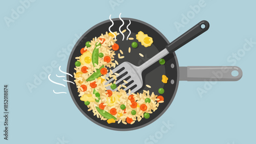 Delicious Fried Rice Cooking in a Hot Pan with Spatula.