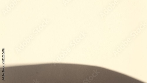 Abstract hand shadow interacting with light reflections. Minimal poetic visual with soft motion and atmospheric mood.