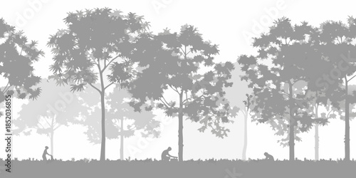 Silhouette of trees and figures cycling in a misty landscape