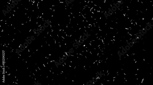 Silver confetti pieces falling down on dark background slowly