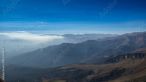 Panoramic view of mountainous terrain under a clear blue sky