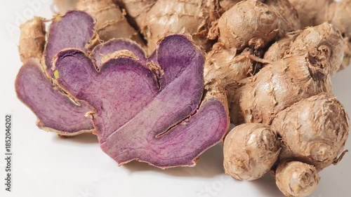 fresh black galingale on white background