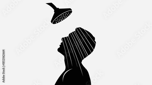 Silhouette of a person taking a refreshing shower under a showerhead.