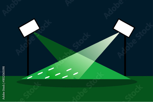 Spotlights illuminating a green field at night