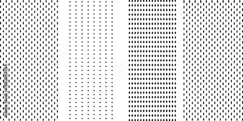 A close up view of a white background with vertical rows of small black dots