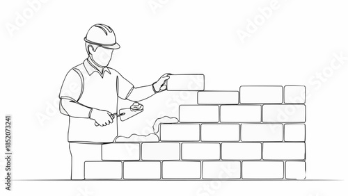 Construction worker building a brick wall with trowel and bricks.