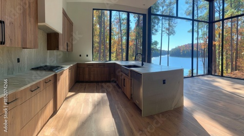 Modern kitchen design with large windows overlooking the forest and lake