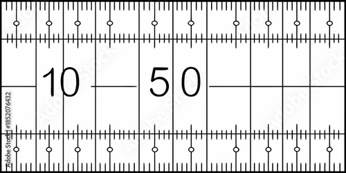 A detailed view of a white ruler with black markings and numerical labels