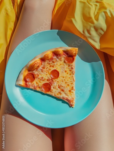 Plate with slice of pizza in woman lap