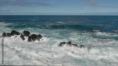 Waves of the Atlantic ocean splashing onto rocks on the coast of Porto Moniz, Madeira, Portugal