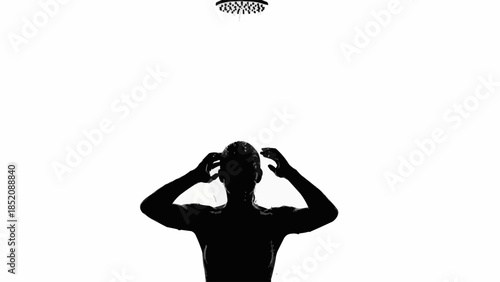 Silhouette of a man in the shower with water falling from above.