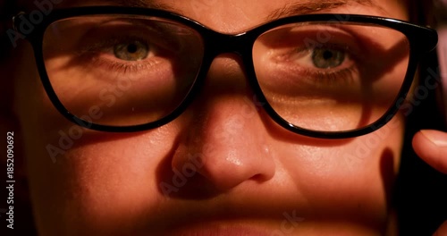Close-Up of Person with Glasses in Dramatic Lighting