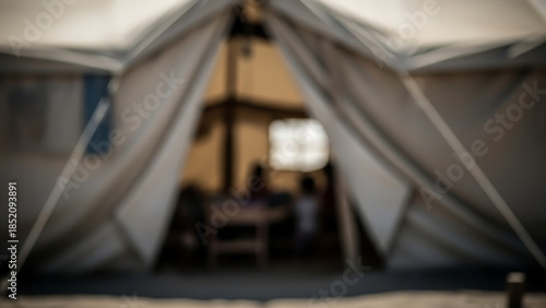 Wallpaper Mural Inside a shelter tent with blurred figures, suggesting refuge or temporary housing Torontodigital.ca