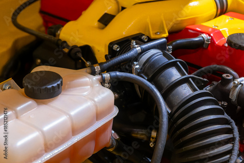 Intricate details of a vibrant engine showcasing intricate mechanics and engineering artistry in a well-lit garage setting