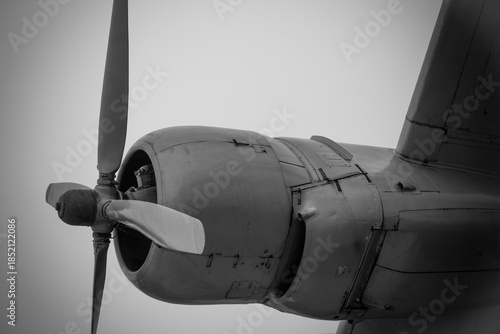 Vintage airplane propeller spinning in the sky during an overcast day, showcasing aviation history and engineering marvels