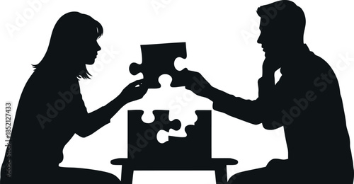 Silhouettes of a man and woman putting together puzzle pieces