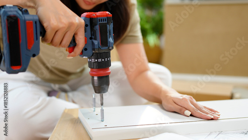 Wallpaper Mural pretty young woman holding screwdriver and repairing or making wooden furniture Torontodigital.ca