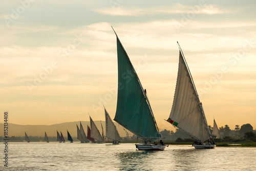 Traditional felucca boats on the Nile River in Aswan. Magnificent view of the Nile at sunset. Aswan, Egypt