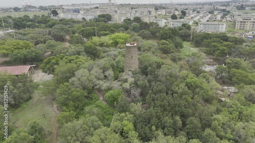 Drone flies back from tower on overcast day in Credo Mutwa Cultural Village, Soweto, South Africa