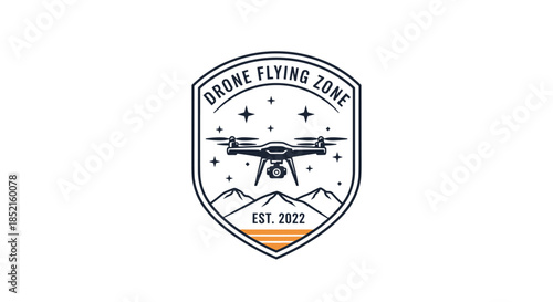 A cool and adventurous emblem for a 'Drone Flying Zone,' featuring a quadcopter over mountains within a shield-shaped patch.