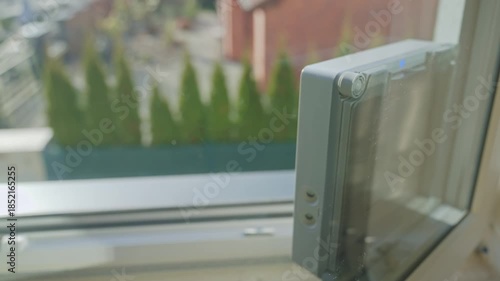 Close up of automatic window cleaning robot. Robotic window cleaner washing glass at home. Concept of smart home appliances