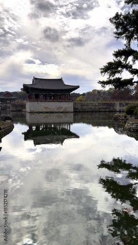 Beautiful view of the historic Anapji pond in Gyeongju, South Korea. Orange koi carp swimming in the calm water reflecting the pagoda