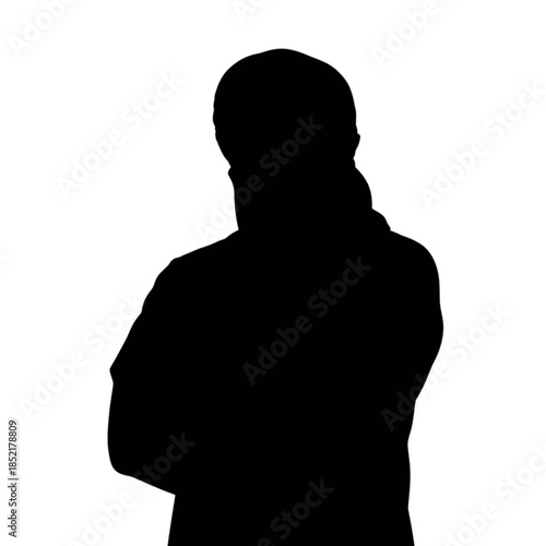 Confident man in traditional clothing smiles at the camera with arms crossed.