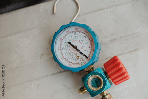 Photography Blue pressure gauge with the arrow pointing at maximum