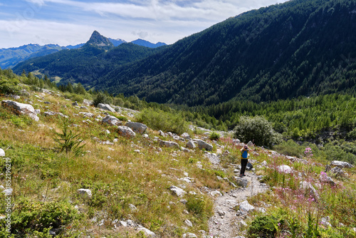 Woman hiking along a trail in Val Veny
