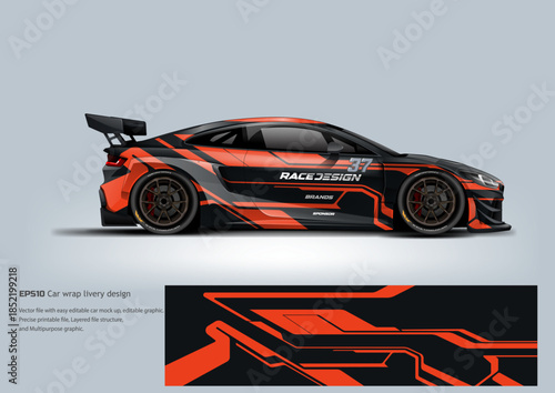 A bold black racing wrap with orange street-style graphics blending track performance with urban aggression.