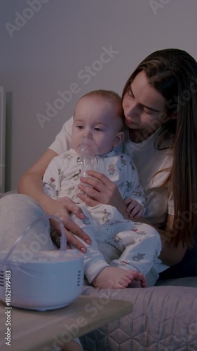 Mother administering inhalation therapy to baby at home, showcasing nurturing care and comfort, camera follows the gentle interaction and connection between them