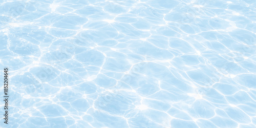 Clear turquoise waves create an abstract liquid pattern on the clean blue water surface of a summer swimming pool with ripples and wet reflections of nature