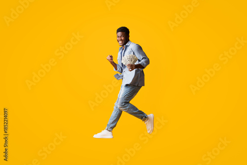 Photography Cheerful lucky handsome young african american man got loan or won lottery, show