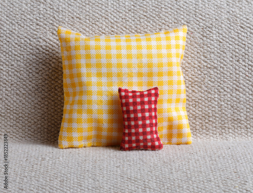 Yellow and red checked cushion on sofa
