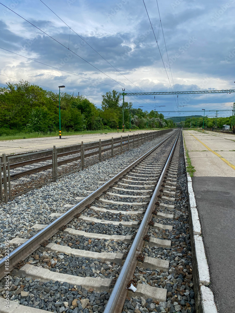 Fototapeta premium railway tracks at empty train station platform