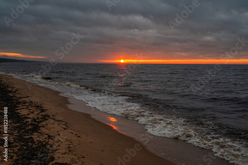 Baltic Sea sunset with waves washing sandy beach in December Latvia