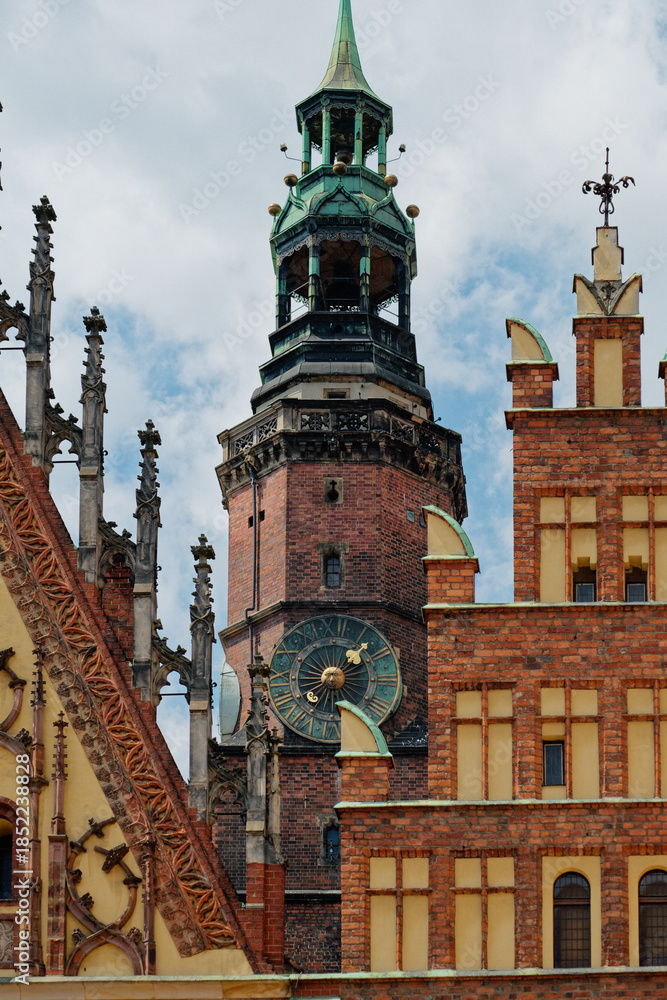 Obraz premium Detailed Perspective Of Medieval Clock Tower Showcasing Ornate Features And Aged Patinas Against Stormy Sky