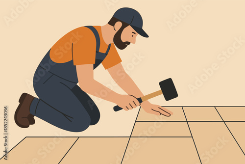 Young caucasian male worker hammering tiles in work clothing