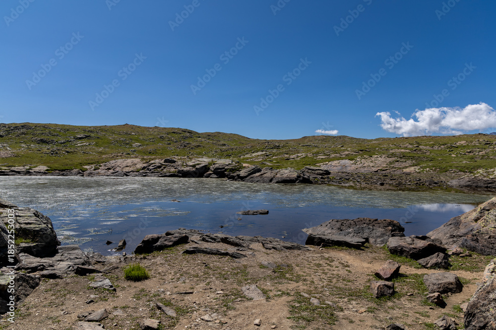 Fototapeta premium Beautiful alpine lake on the Emparis Plateau in the Arves Massif, Hautes-Alpes, France.