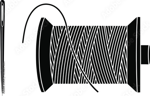 Black and white of a sewing needle and a spool of thread spool