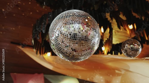 A dazzling disco ball radiates light in a vibrant setting, ideal for unforgettable parties and celebrations