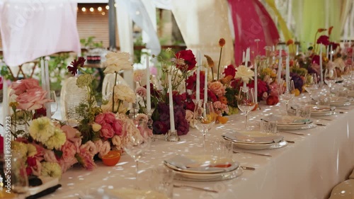 Opulent wedding decor with candles and blossoms, Luxurious floral arrangement for wedding with candles and beautiful blooms