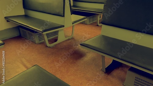 Inside a salon with empty passenger seats of city rail transports. Seats in old cabin of passenger train. Old interior of urban railway. Old leather armchair seat on passenger train. Salon Interior 
