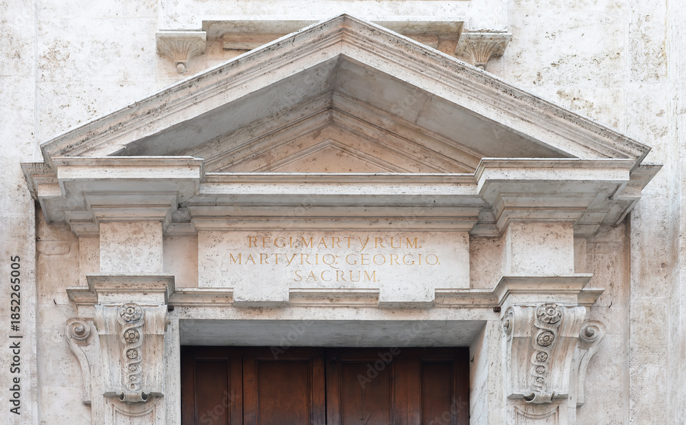 Naklejka premium Marble tympanum with Latin text on the lintel dedicated to Saint George and other martyrs on the San Giorgio church in Siena, Italy
