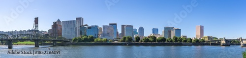 A downtown panorama view of the city of Portland Oregon skyline and highrise skyscraper buildings and bridges along the Willamette River.