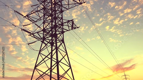 Power Tower With Wires on Colorful Sky at Dusk sunset. Sunset View of Tall Power tower on dusk sky filled with clouds. Electric tower. Transmission Lines Tower Erection. High voltage sunset.